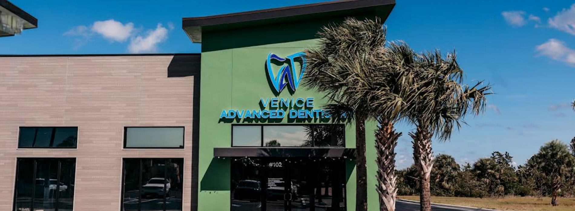 The image shows a modern dental clinic interior with various pieces of equipment, including a dental chair and an X-ray machine.